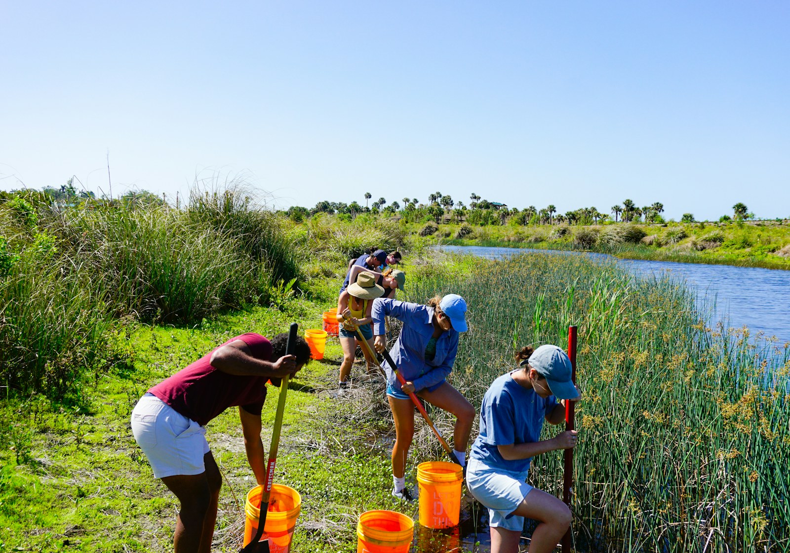 Young people learning beside water